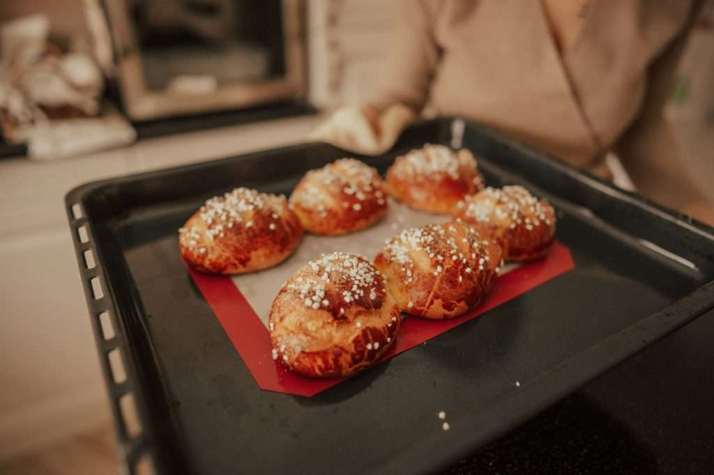 Baked tasty brioches are cooked for breakfast. Small business concept