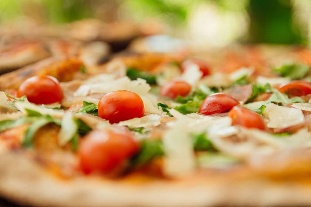 close up of a cherry tomato on a pizza. delicious homemade pizza