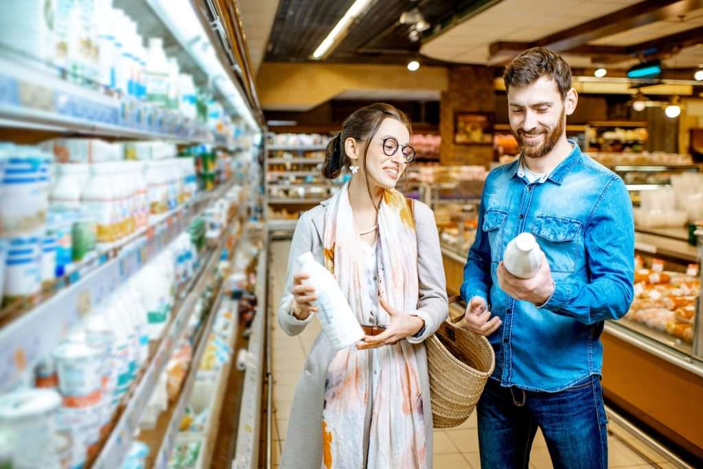 Couple buying dairy products in the supermarket