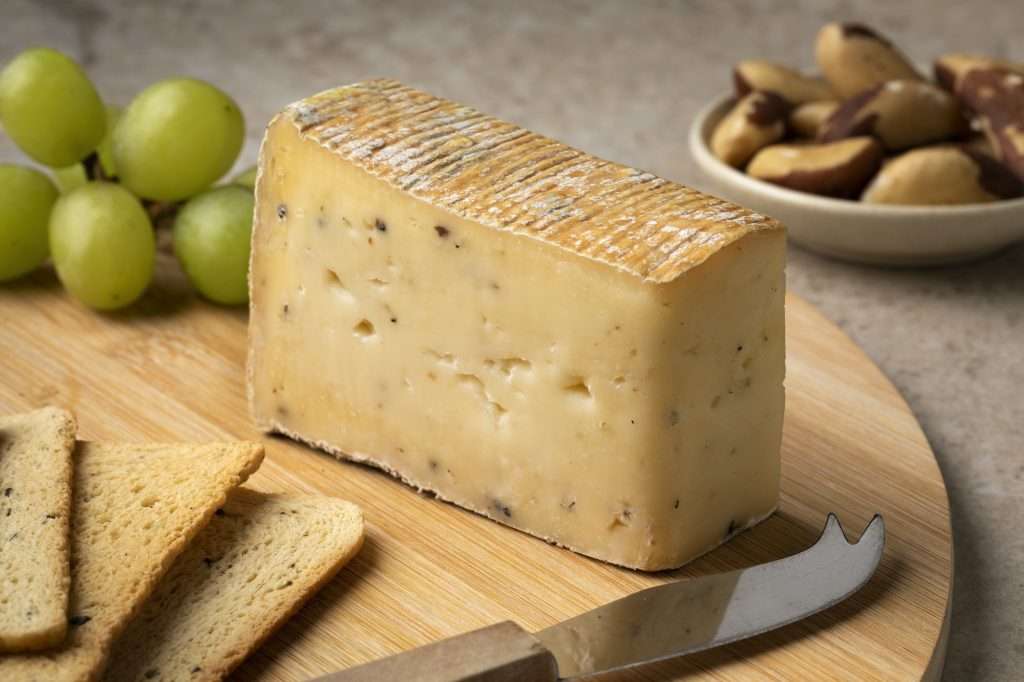 Cutting board with Italian Taleggio Tartufo cheese close up