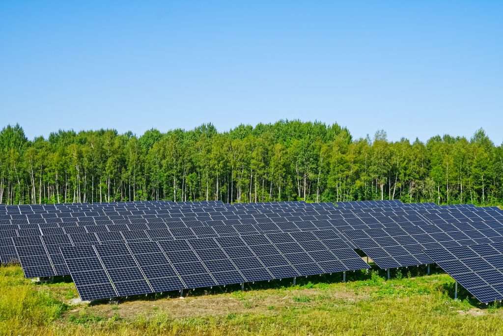 Solar power plant in summer day. Photovoltaic panels for renewable electric production.