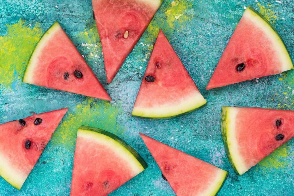 Watermelon slices on vibrant concrete slate