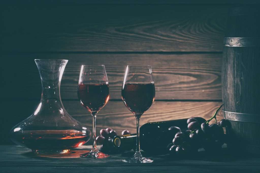 Wine still life with red wine in glasses and grapes